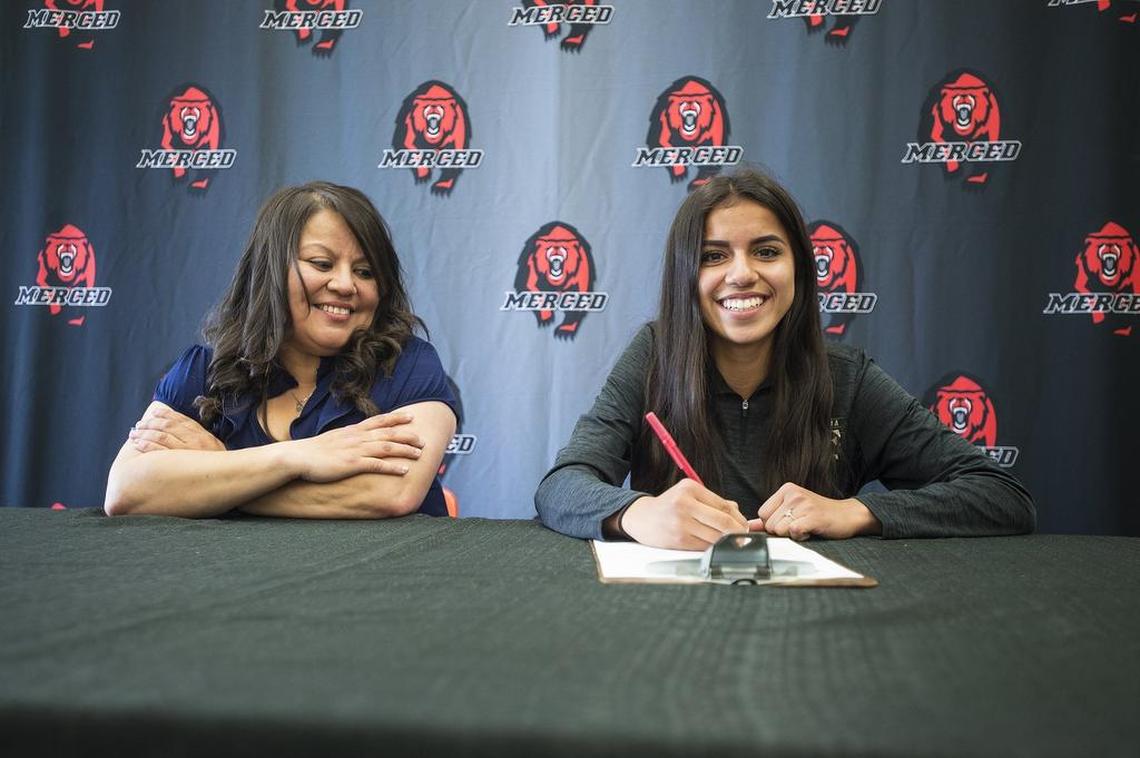 Merced's Ciara Colon, right, sits with her mother Lupe, left, during a signing ceremony at Merced High School in Merced, Calif., on Wednesday, April 18, 2018. Colon has signed her letter of intent to attend and run cross country at California State University, Stanislaus.