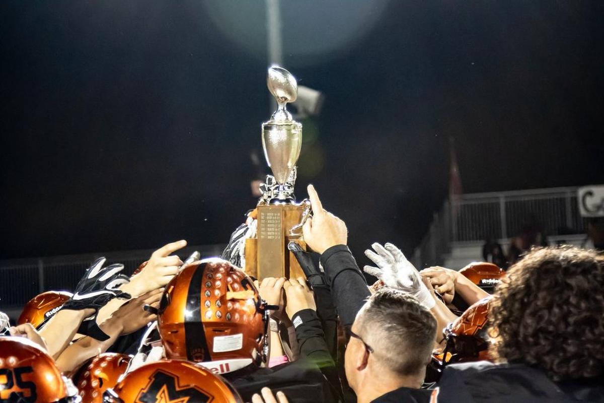 The Merced High football team holds up the Mayor’s Cup trophy after defeating Golden Valley 41-7 on Friday night at Veterans Stadium in Merced, Calif.