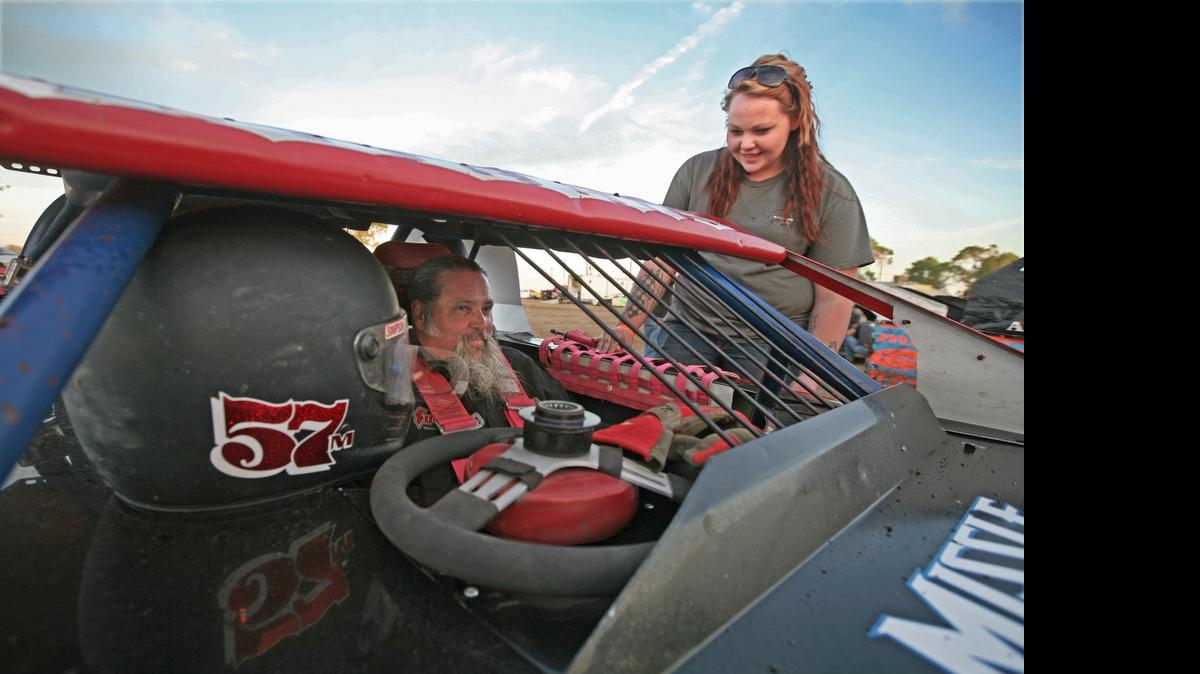 
Marissa Odgers helps her dad, Mark, prepare for an IMCA SportMod race. Both race, and both serve as the other’s pit crew.
