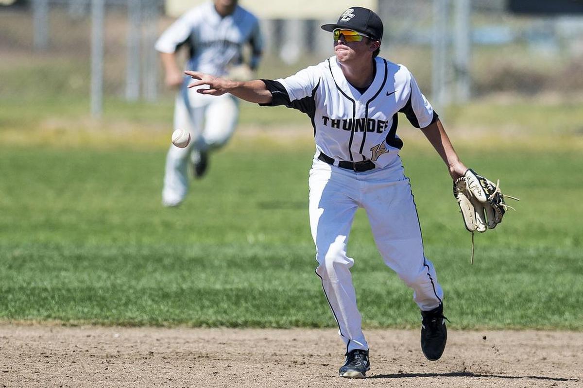 Buhach Colony sophomore Nathan Farrar (12) tosses the ball to second base for an out during a game against Merced at Buhach Colony High School in Atwater, Calif., on Saturday, April 21, 2018. The Thunder beat the Bears 7-0.