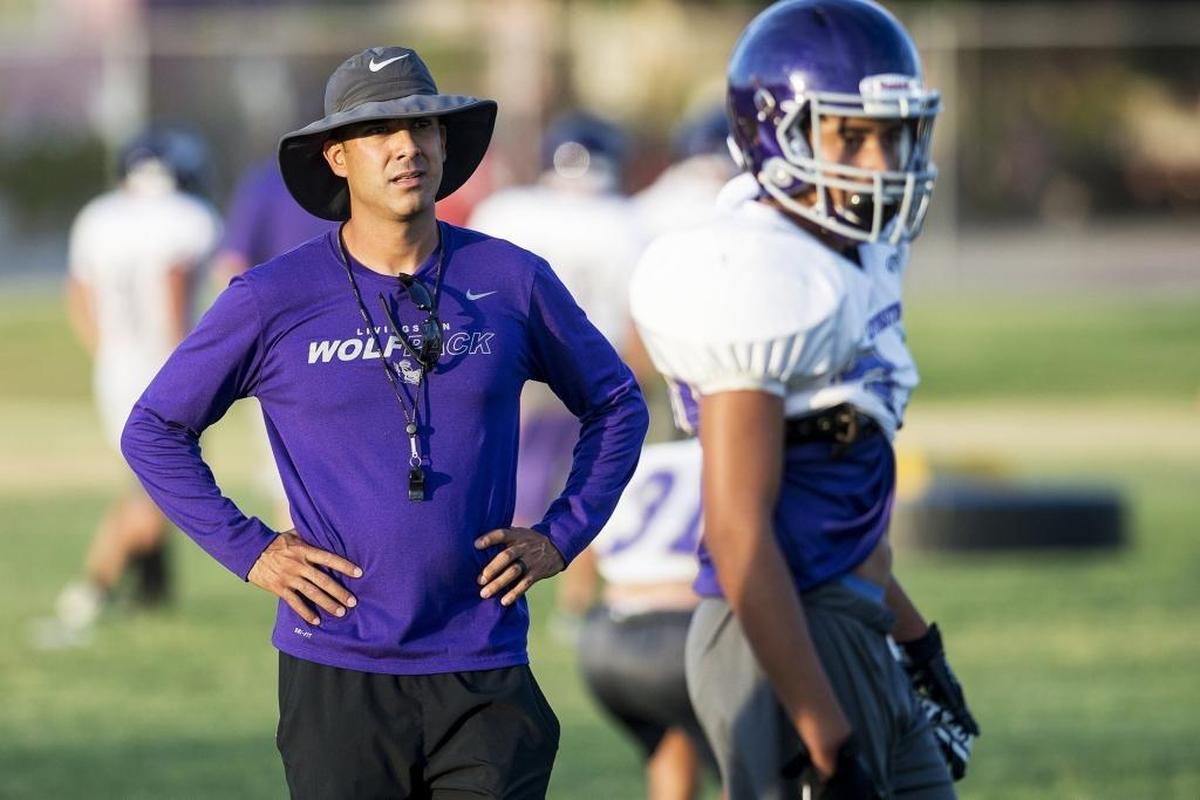 Head coach Alex Gonzalez looks on during football practice at Livingston High School in Livingston, Calif., on Wednesday, July 25, 2018.