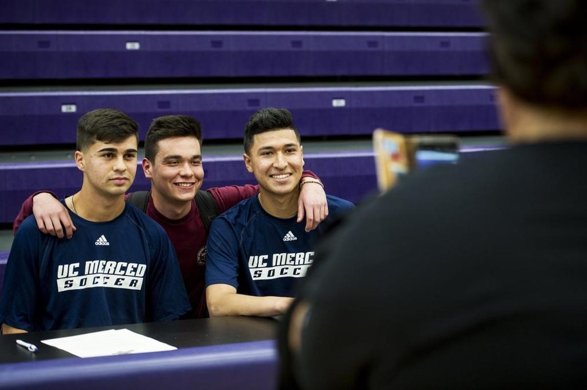Livingston High School's Francisco Lopez, left, and Marco Sobrevilla, right, pose for a photo with senior Dominic Maldonado, center, following a letter of intent signing ceremony in the school’s gymnasium in Livingston, Calif., on Tuesday, April 17, 2018. Lopez and Sobrevilla have both signed a letter of intent to attend and play soccer for the University of California, Merced.