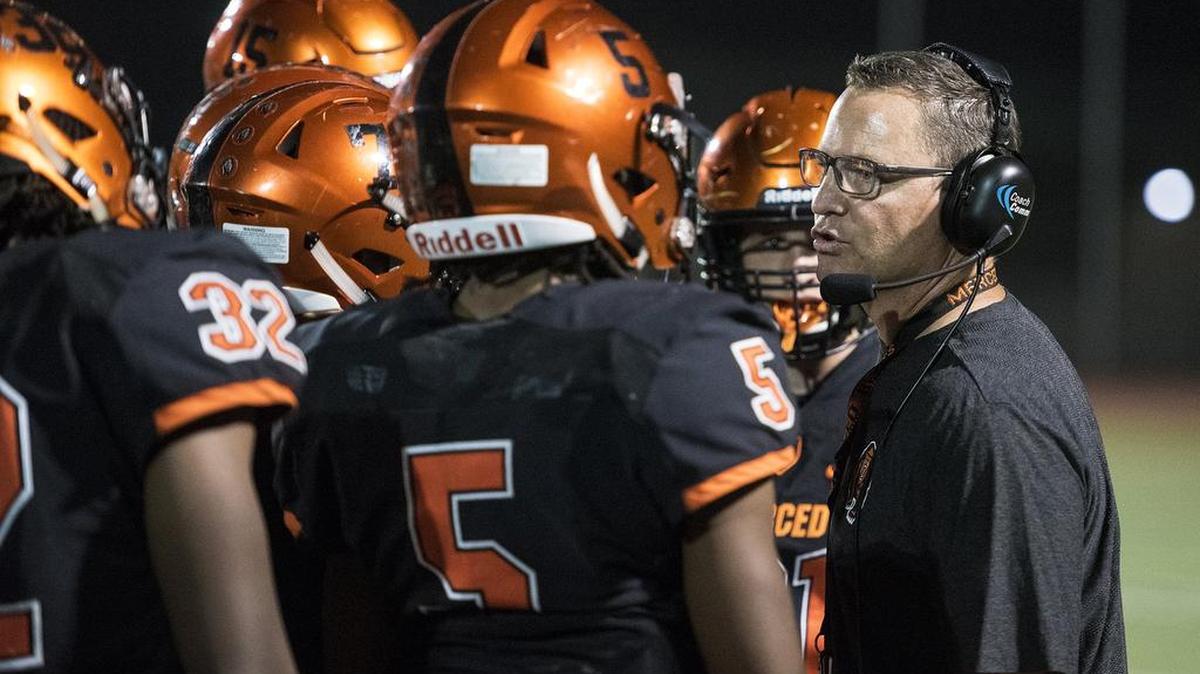 Merced head coach Rob Scheidt speaks to his players during a game against Gregori at Veterans Stadium on the campus of Golden Valley High School in Merced, Calif., on Friday, Aug. 24, 2018. The Bears beat the Jaguars 41-22.