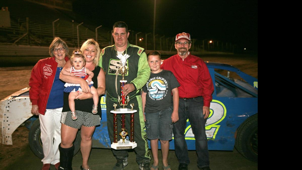 The Stofle Family shares victory lane with Ted Stofle Classic Hobby Stock winner Michael Shearer. From left is Ted's mother, Harlene Stofle, daughter Melissa Sousa (holding granddaughter Ashley Sousa), Shearer and his son, and Gary Stofle, brother of Ted.