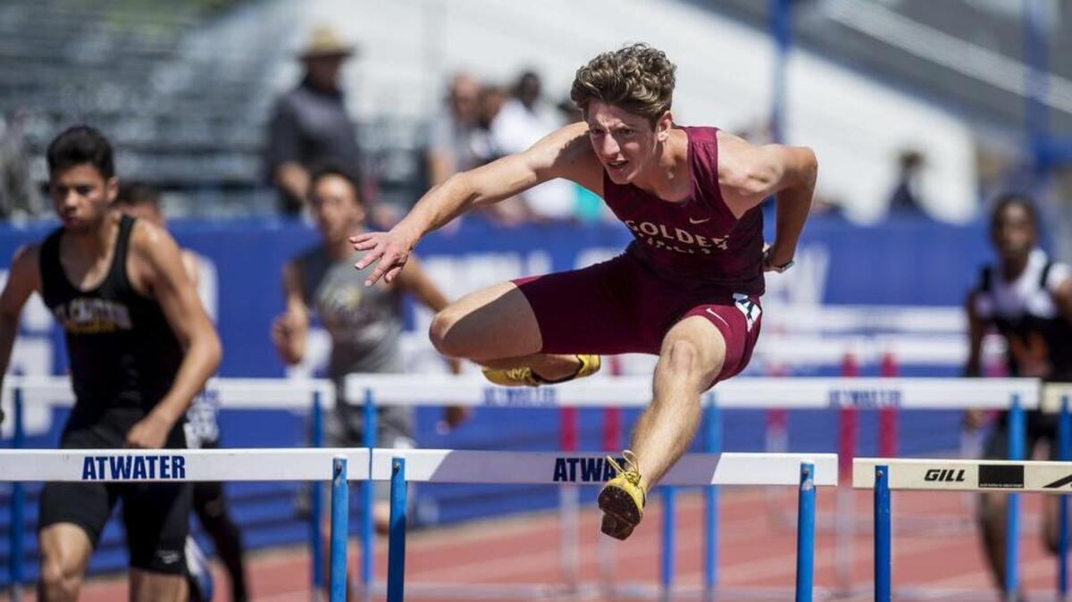 Golden Valley senior Michele Del Corona clears the final hurdle and goes on to win the boys 110 meter hurdles during a Central California Conference Center Meet at Atwater High School in Atwater, Calif., on Wednesday, April 25, 2018.