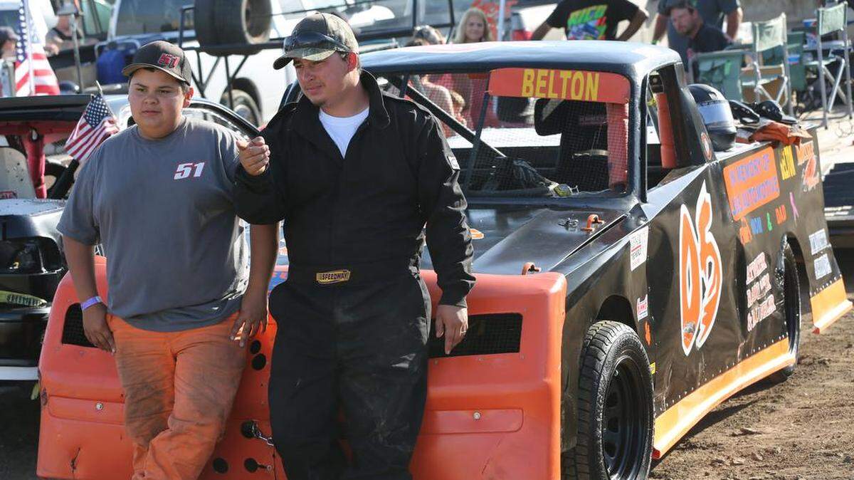 Eighth grader Devin Belton, left, gets advice from his big brother, Jason Belton, Jr. as he prepares to drive his pick-up truck in the Mini-Stock division at Merced Speedway. Mike Adaskaveg Photo