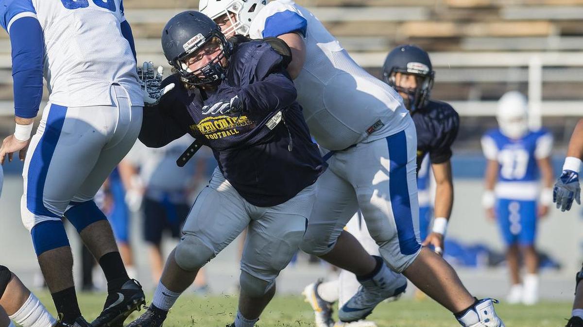 Merced College’s Hunter Stefani gets past a Modesto Junior College blocker during a scrimmage at Stadium ’76 earlier this year. The Blue Devils will try to pick up their first win on Saturday night at home against De Anza.