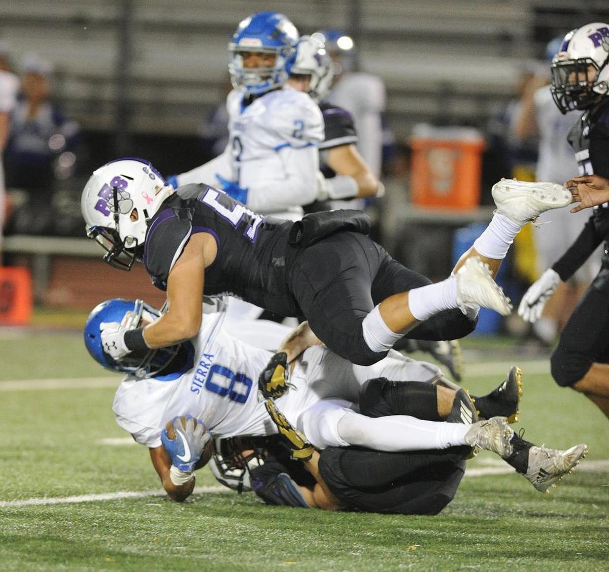 Pacheco High linebacker, Gilbert Montoya, top, lands on Sierra High running back, Matt Dunham in the first quarter Fri., Nov. 2, 2018 at Veterans Stadium in Los Banos.