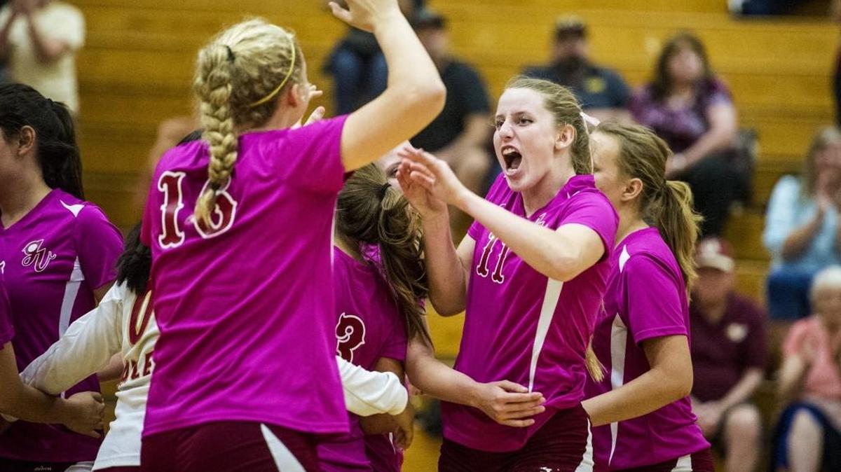 
Golden Valley senior Stephanie Moore (11) and junior Abbee Croninger (16) high-five while celebrating a 3-0 Cougar win over the Merced Bears at Golden Valley High School in Merced, Calif., Wednesday, Oct. 14, 2015.
