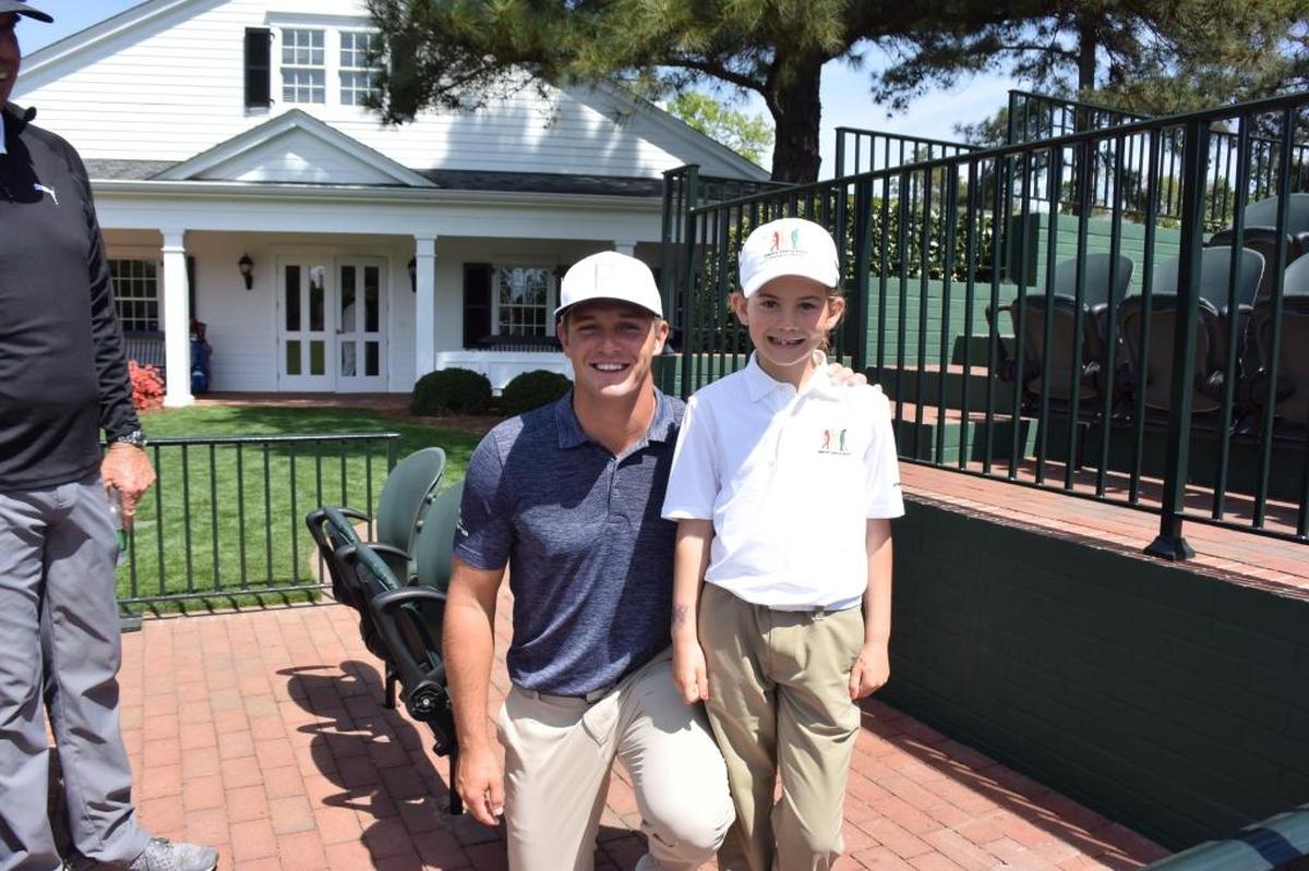 Chowchill's Asterisk Talley poses for picture with professional golfer Bryson DeChambeau at the Augusta National Golf Club.