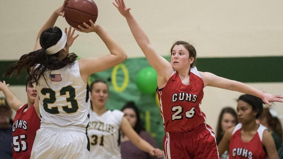 Chowchilla sophomore Kiley Garvey (24) attempts to block a shot by Mariposa junior Milea Appling (23) during a CIF Northern California Regional Division V playoff game at Mariposa County High School in Mariposa, Calif., on Wednesday, March 7, 2018. The Tribe beat the Grizzlies 43-25.