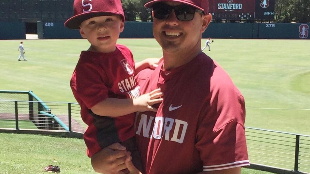 Thomas Eager and his 3-year old son, Trey, are all decked out in Stanford gear after Eager was hired as the new Stanford pitching coach this summer.