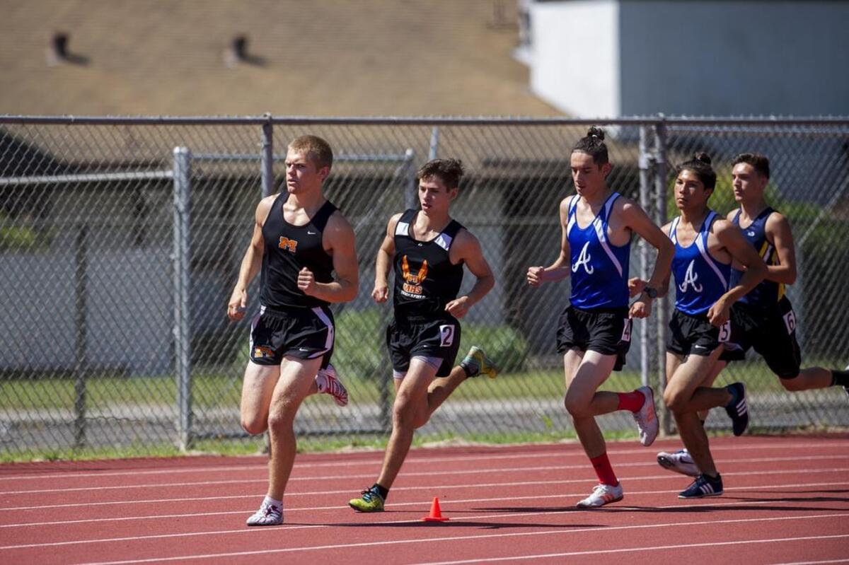 Merced's John Hagerman leads the field into the first turn in the boys 1600 meter race during a Central California Conference Center Meet at Atwater High School in Atwater, Calif., on Wednesday, April 25, 2018.