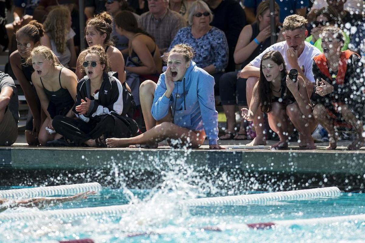 People cheer on swimmers from the pool deck during the Central California Conference Championships at Golden Valley High School in Merced, Calif., on Saturday, April 28, 2018.