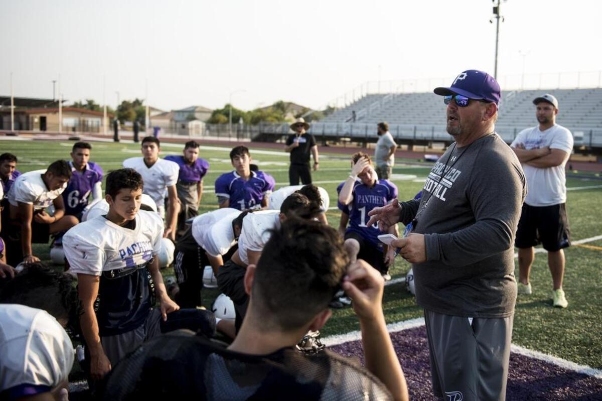 Pacheco head coach David Snapp speaks to players during football practice at Pacheco High School in Los Banos, Calif., on Thursday, July 26, 2018.