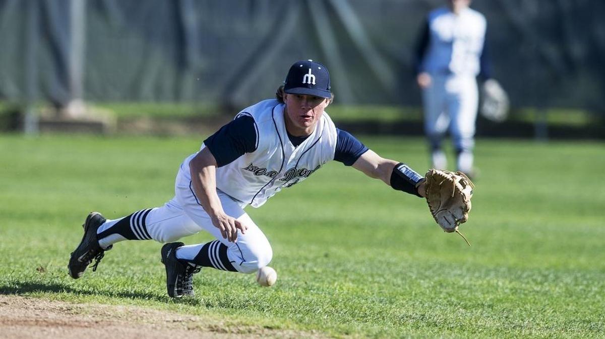 Merced College sophomore Tanner Browning (14) dives for the ball at second base during a game against Solano College at Blue Devil Field in Merced, Calif., on Saturday, Jan. 27, 2018.