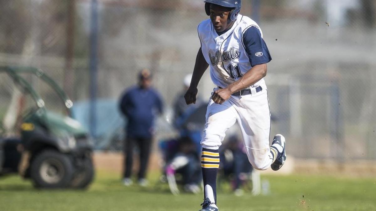 Merced College sophomore Lawrence Anderson (11) runs down the third base line to score a run during a game against Diablo Valley College at Merced College in Merced, Calif., Saturday, Feb. 6, 2016.