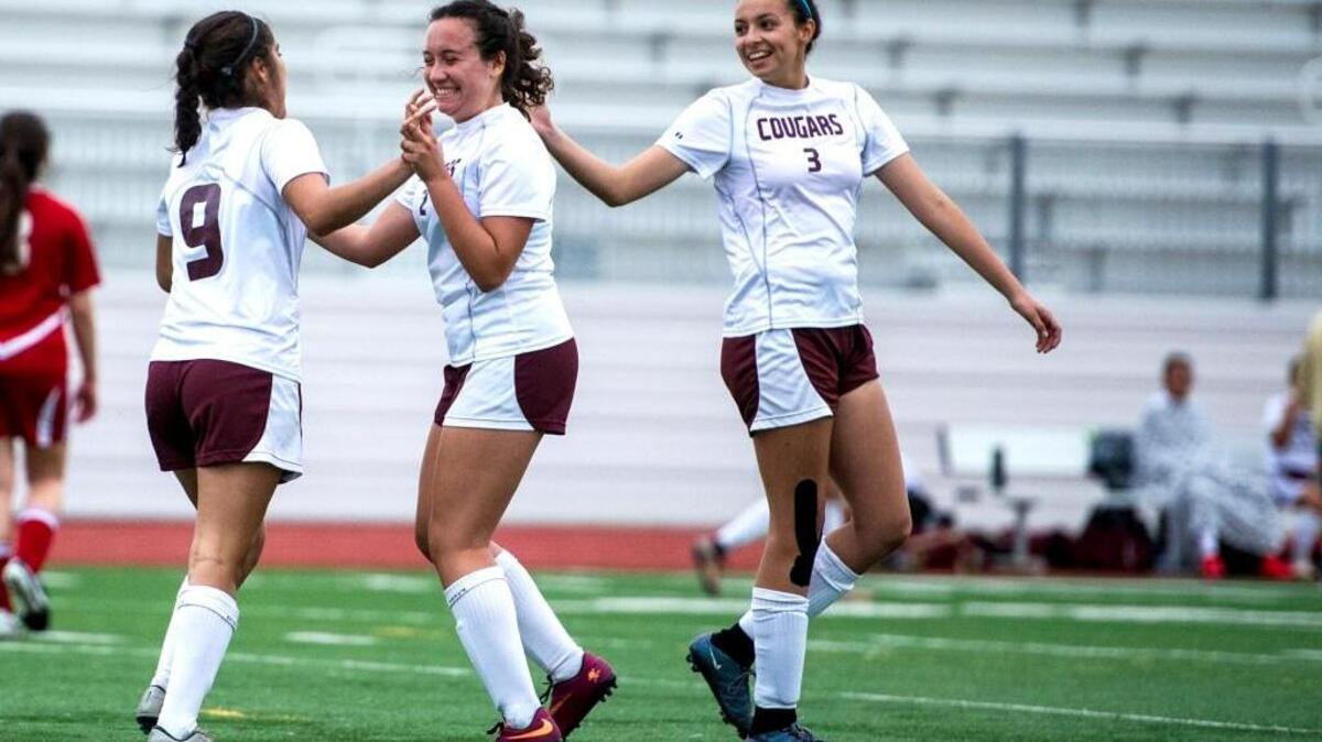 Golden Valley senior Brandy Cervantes (9) celebrates her second half goal with teammates Sheree Osborne (9) and Justyne Sanchez (3) during a game against Patterson at Golden Valley High School in Merced, Calif., Thursday, March 10, 2016. The Cougars beat the Tigers 8-1.