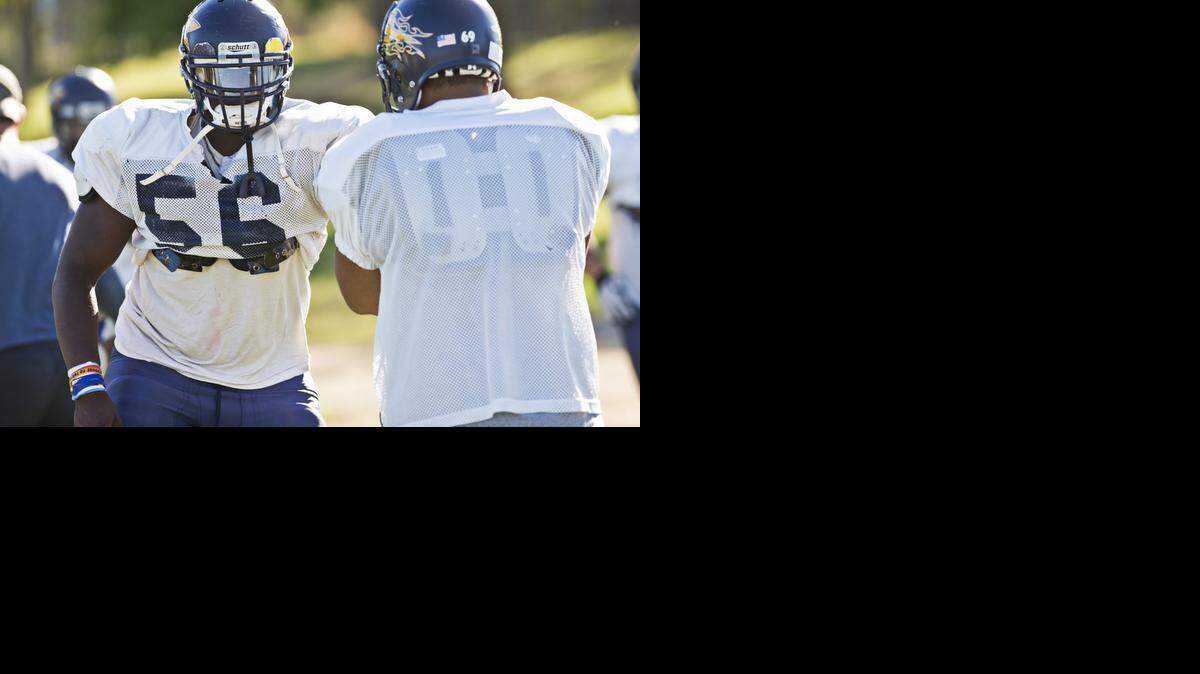 
Merced College freshman offensive lineman Ty Allen blocks during Merced College football practice on Tuesday, Oct. 28, 2014.
