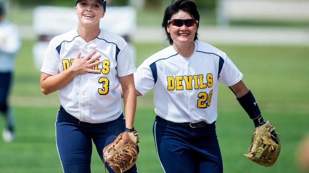 Merced College freshman Shelbee Ward (3) takes a deep breath next to freshman teammate Arisa Nishibe (20) during a game April 19 against Reedley College at Merced College. The Blue Devils beat the Tigers 2-1.