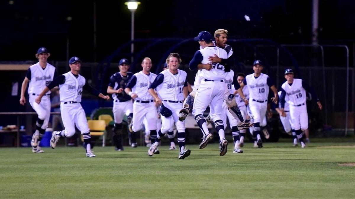 Merced College pitcher Nicholas Gonzales (22) and catcher Omar Sanchez leap into each other's arms as the rest of the Blue Devils sprint out of the dugout after Thursday's Central Valley Conference title-clinching victory over Reedley. Thursday, April 20, 2017 in Merced.