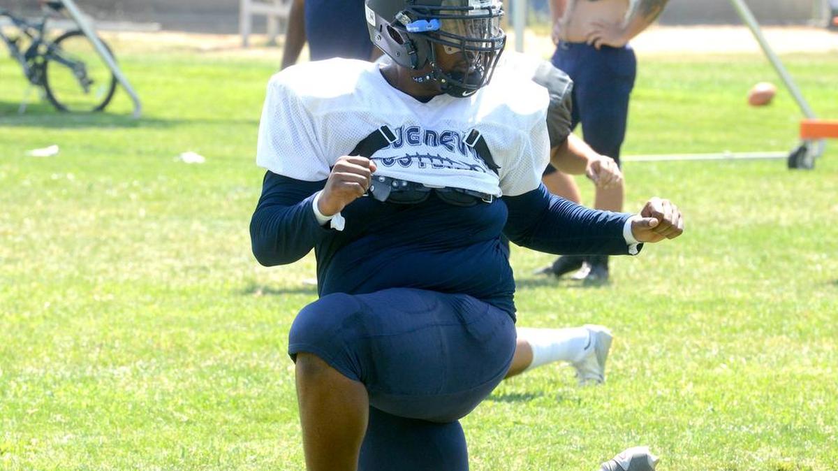 
Merced College offensive lineman  Xzavier McAllister stretches during the team’s warmup at practice Monday.
