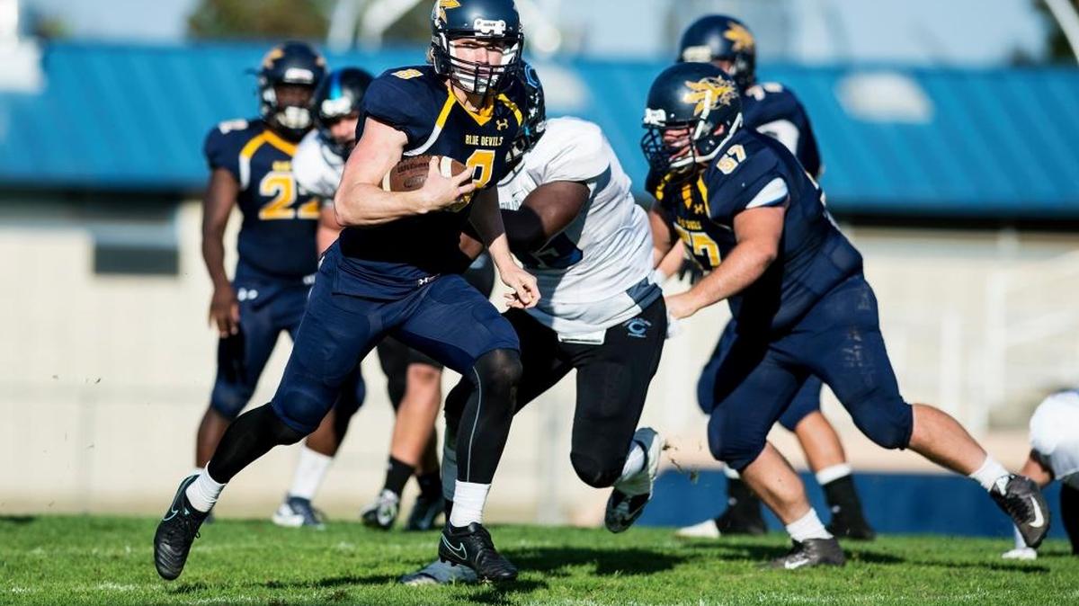 Merced College sophomore quarterback Noah Croninger (8) scrambles upfield during a game against Cabrillo College at Stadium '76 in Merced, Calif., Saturday, Nov. 12, 2016. The Blue Devils beat the Seahawks 48-0.