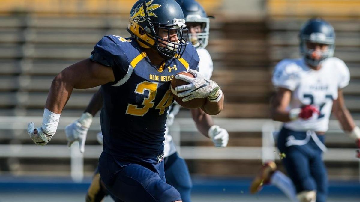 Merced College freshman running back Hanisi Lotulelei (34) rushes for a touchdown during a game against Yuba College at Stadium '76 earlier this season.