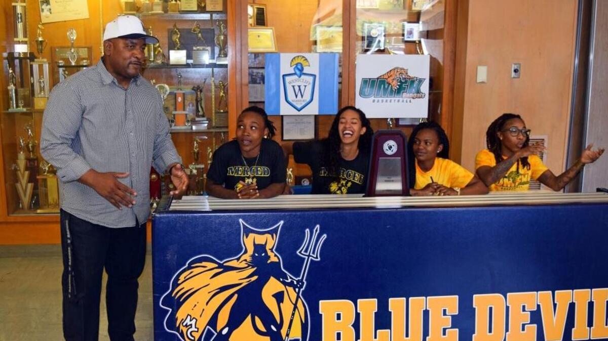 Merced College women's basketball Allen Huddleston speaks before four Lady Blue Devils players sign their national letters of intent on Tuesday at Merced College. From left to right: Merced College's Champelle Kelly and Jordan Pierce signed with Westcliff University in Irvine. Tajaheray McMahan and Trinity Washington signed with the University of Maine at Fort Kent.