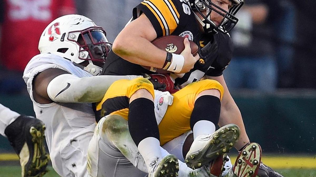 Iowa quarterback C.J. Beathard, right, is sacked by Stanford defensive end Aziz Shittu during the second half of the Rose Bowl NCAA college football game, Friday, Jan. 1, 2016, in Pasadena.