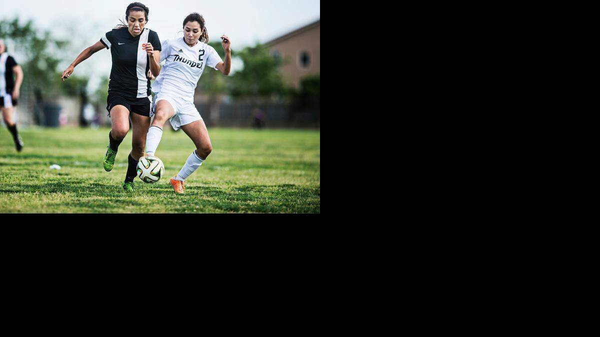 
Merced senior Justine Ramos (2) attempts to steal the ball from Merced senior Hannah Esquivel (9) during a game at Buhach Colony High School in Atwater, Calif., Tuesday, March 24, 2015. The Bears beat the Thunder 3-0.

