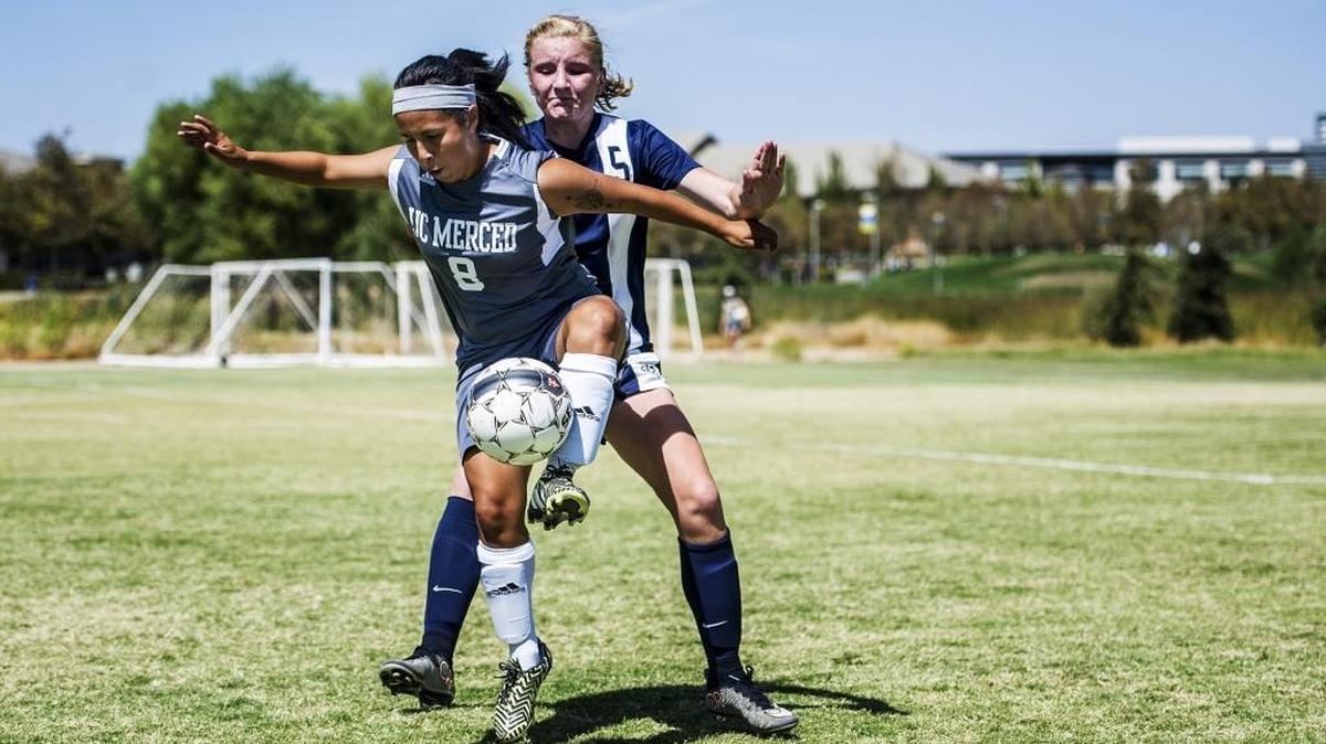
UC Merced junior Karen Lepe (8) protects the ball from Oregon Tech freshman Sydney Nett on Tuesday.
