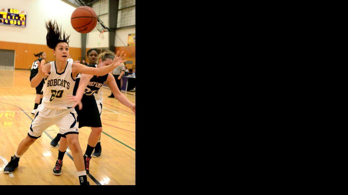 UC Merced's Adrienne Carmona reaches for a loose ball during the Bobcats’ game against Holy Names in Merced Wednesday. (11-21-12).