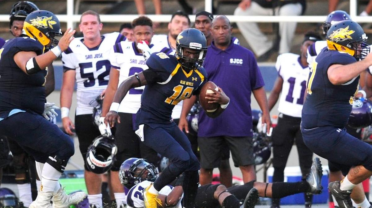 Merced's Marc Aristide (18) leaves San Jose's Omar Elserogy (21) on the ground while returning a punt into San Jose territory, during a Saturday night community college football matchup between San Jose City College and Merced College at Stadium 76 in Merced, Calif. on September 9, 2017.