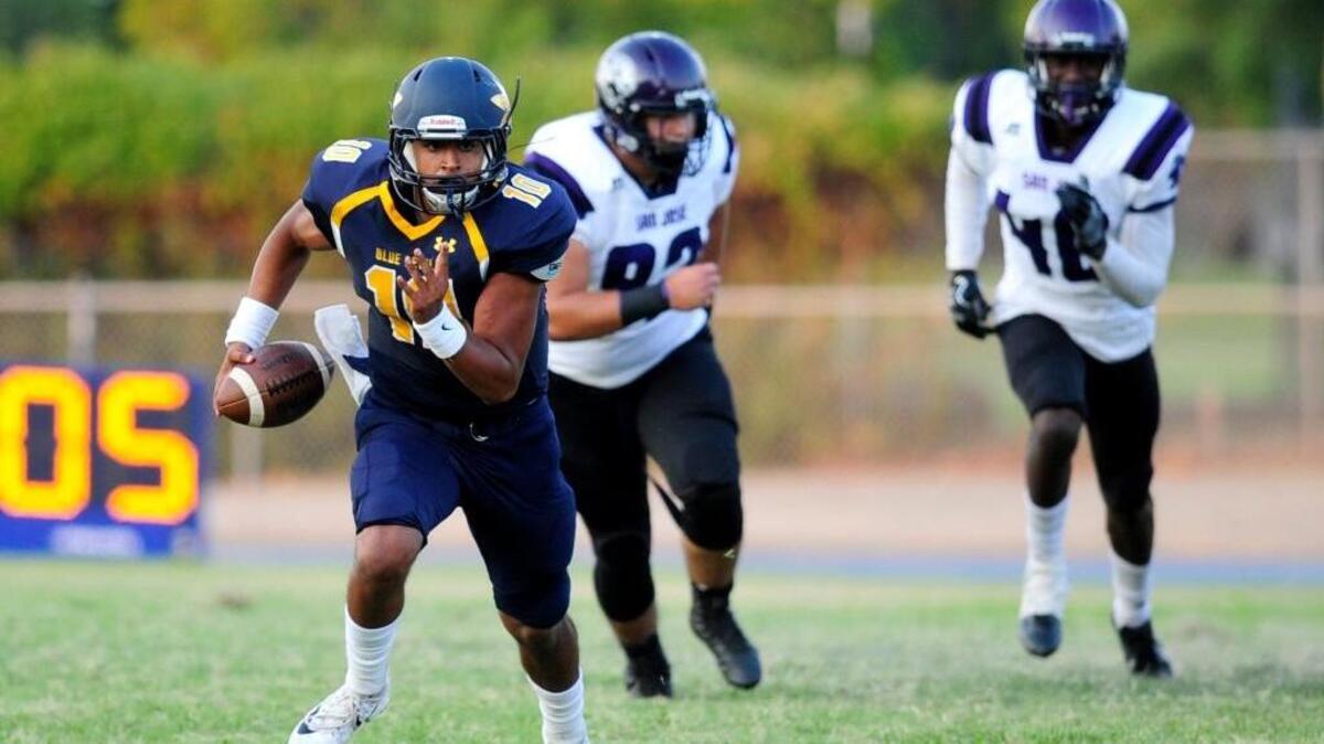Merced QB Frank Cocio (10) keeps the ball and looks for room to run, during a Saturday night community college football matchup between San Jose City College and Merced College at Stadium 76 in Merced, Calif. on September 9, 2017.
