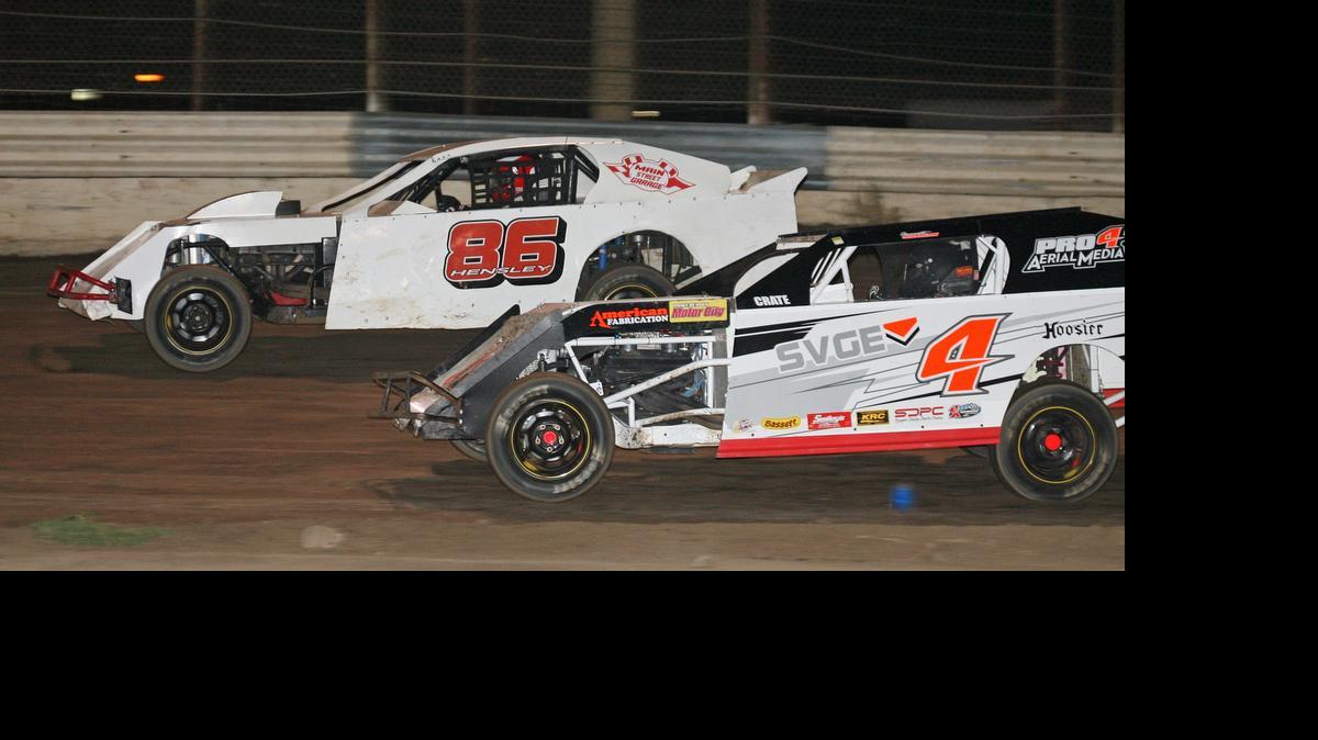 Jo sh Hensley (86) of Ballico, racing alongside Garrett Jernagan of Bakersfield (4) during IMCA SportMod action at Merced Speedway, leads points but wants a win.