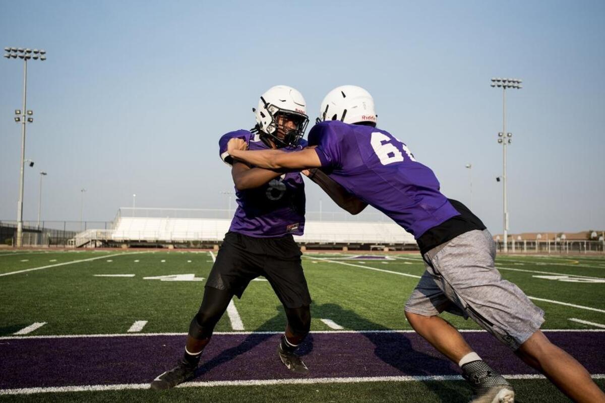 Pacheco players run through drills during football practice at Pacheco High School in Los Banos, Calif., on Thursday, July 26, 2018.