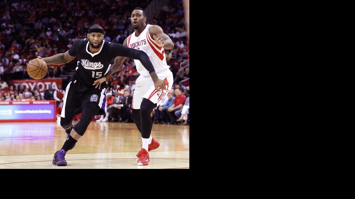 DeMarcus Cousins drives past Houston Rockets’ Joey Dorsey in the first half of a basketball game Wednesday in Houston. The Kings lost 115-111 to Houston.