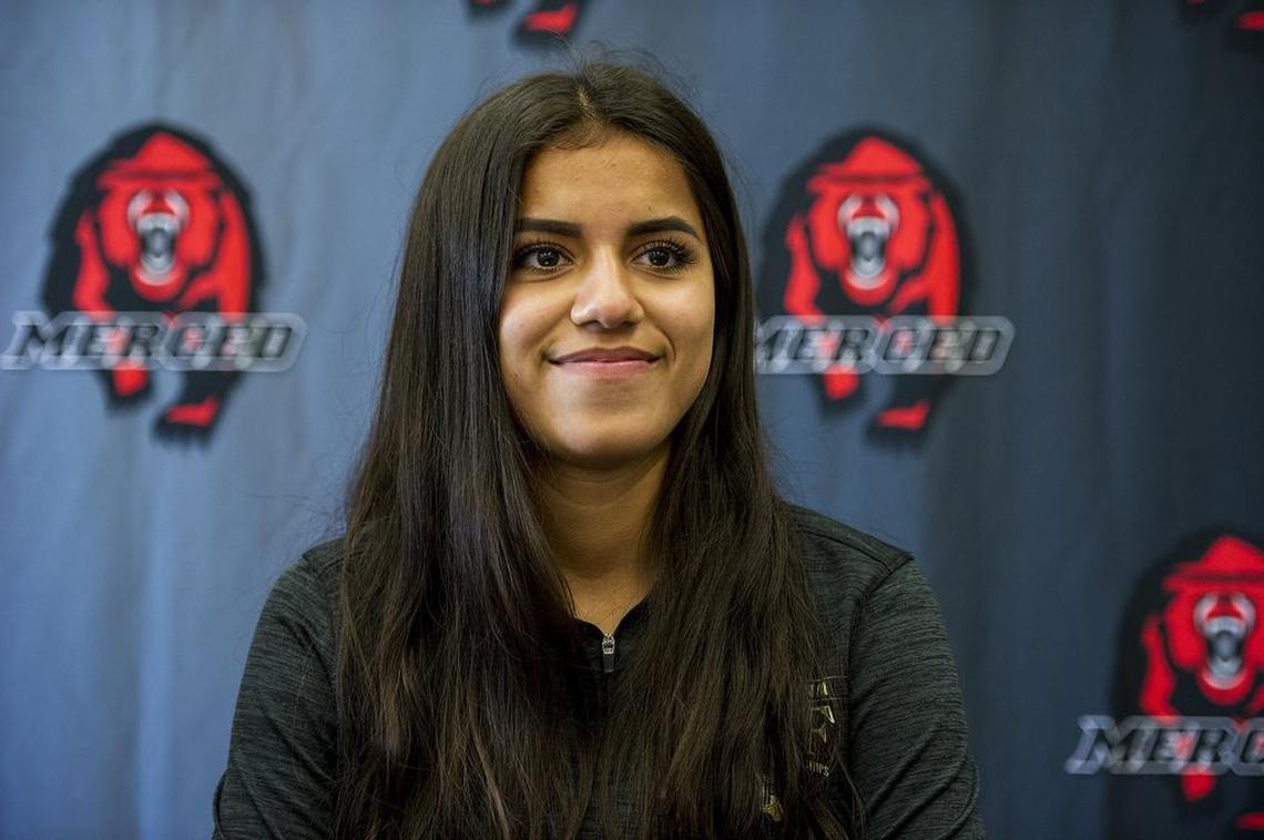 Merced's Ciara Colon smiles at friends during a signing ceremony at Merced High School in Merced, Calif., on Wednesday, April 18, 2018. Colon has signed her letter of intent to attend and run cross country at California State University, Stanislaus.