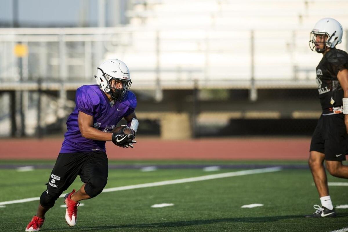 Pacheco’s Ronnie Garcia rushes the ball during football practice at Pacheco High School in Los Banos, Calif., on Thursday, July 26, 2018.