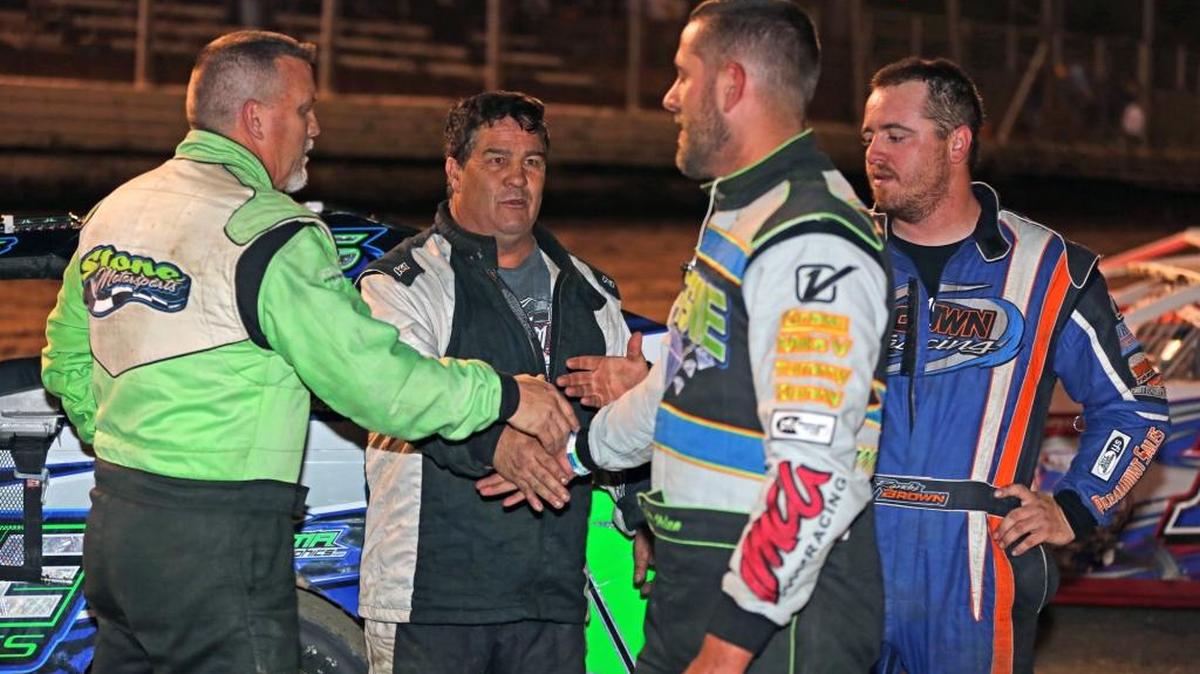 Atwater’s Bill Egleston, second from the left, who finished second in the feature event at Merced Speedway on April 2, congratulates fellow drivers Paul Stone of Winton, left; Bruce “Bubba” Nelson of Turlock second from the right, and Randy Brown of Chowchilla, right.