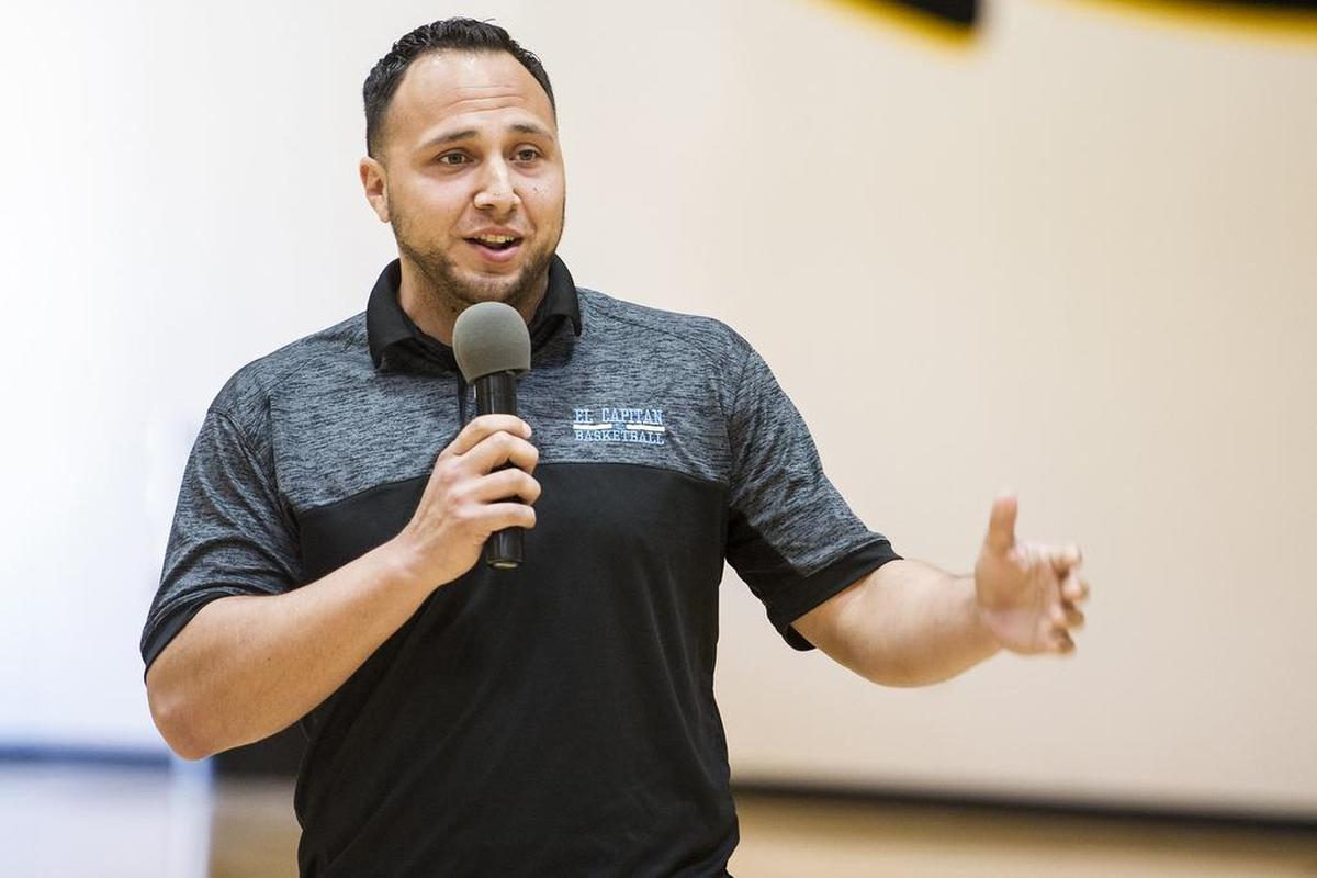 El Capitan boys varsity basketball coach Adrian Hurtado, speaks during a ceremony for senior Angel Serena at El Capitan High School in Merced, Calif., on Friday, April 27, 2018. Serena signed his letter of intent to attend and play basketball for the University of California, Merced.
