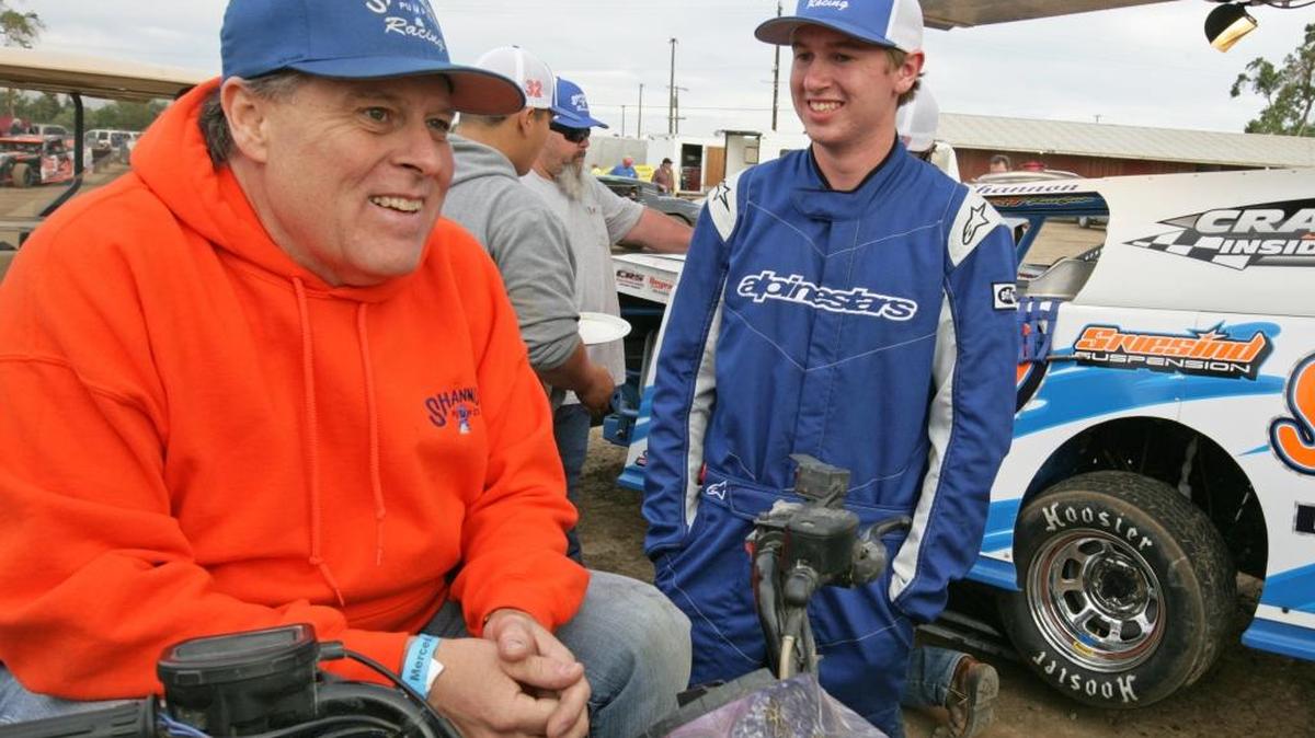 Merced Speedway champ Chris Shannon, left, talks with his son, D.J. before taking to the track at Merced Speedway two weeks ago.