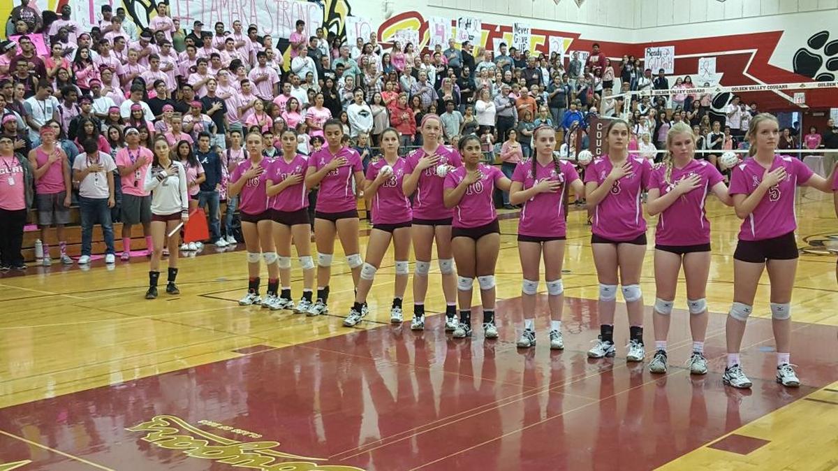 The Golden Valley High volleyball players stand for the National Anthem before Tuesday night’s “Pink Out” game against Merced at Cougar Arena. The game was in honor of Golden Valley High nurse Tamara Simmons, who was recently diagnosed with breast cancer.