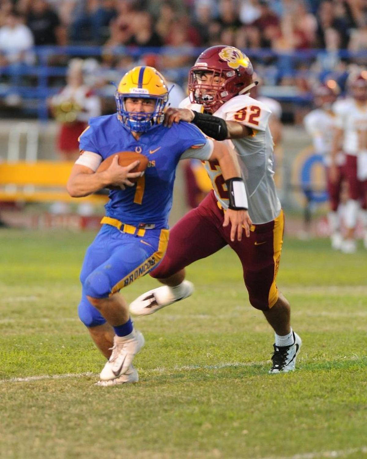 Los Banos linebacker, Junor Lemos, right, tackles Dos Palos High quarterback Isaac Adams in the first quarter Fri., Aug. 17, 2018 in Dos Palos.