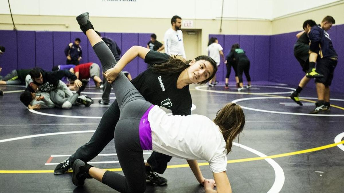 Livingston freshman Charla Baptista takes down junior Natalie Perez during wrestling practice at Livingston High School in Livingston, Calif., on Thursday, Feb. 4, 2016. They are part of the first local girls wrestling team to win a conference championship.