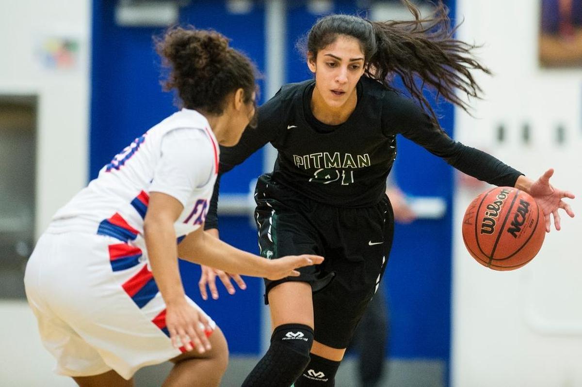 Pitman junior Kaylin Randhawa (21) dribbles up the court during a game against Atwater at Atwater High School in Atwater, Calif., on Tuesday, Jan. 24, 2017. The Pride beat the Falcons 45-43.