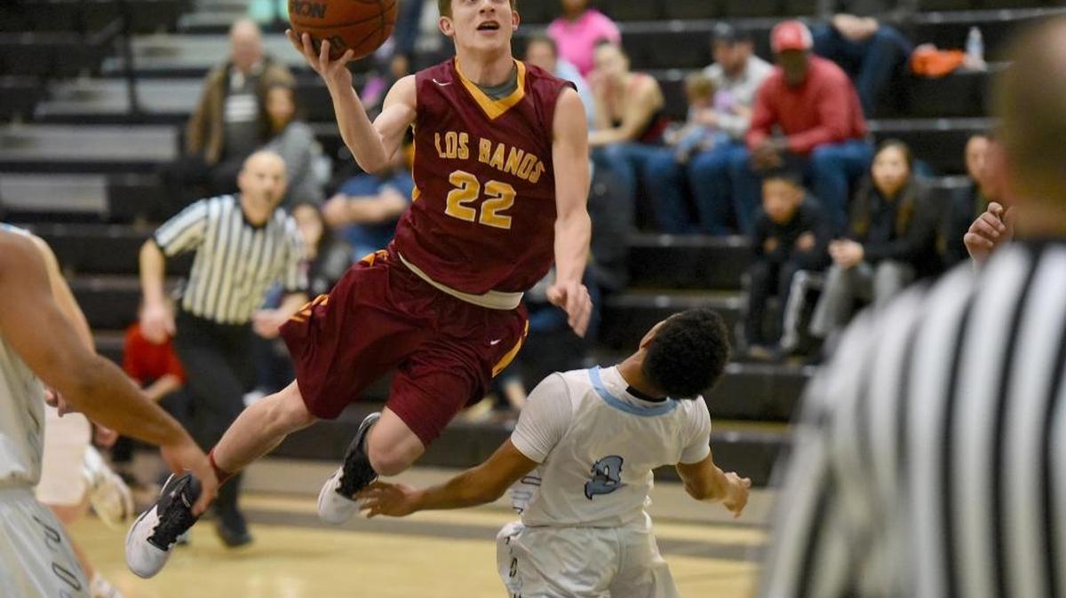 El Capitan's Isaiah Knott (3) draws a charge from Los Banos' Cameryn Gomez during the Gauchos' 53-30 victory on Wednesday night. Wednesday, Jan. 20, 2016 in Merced.