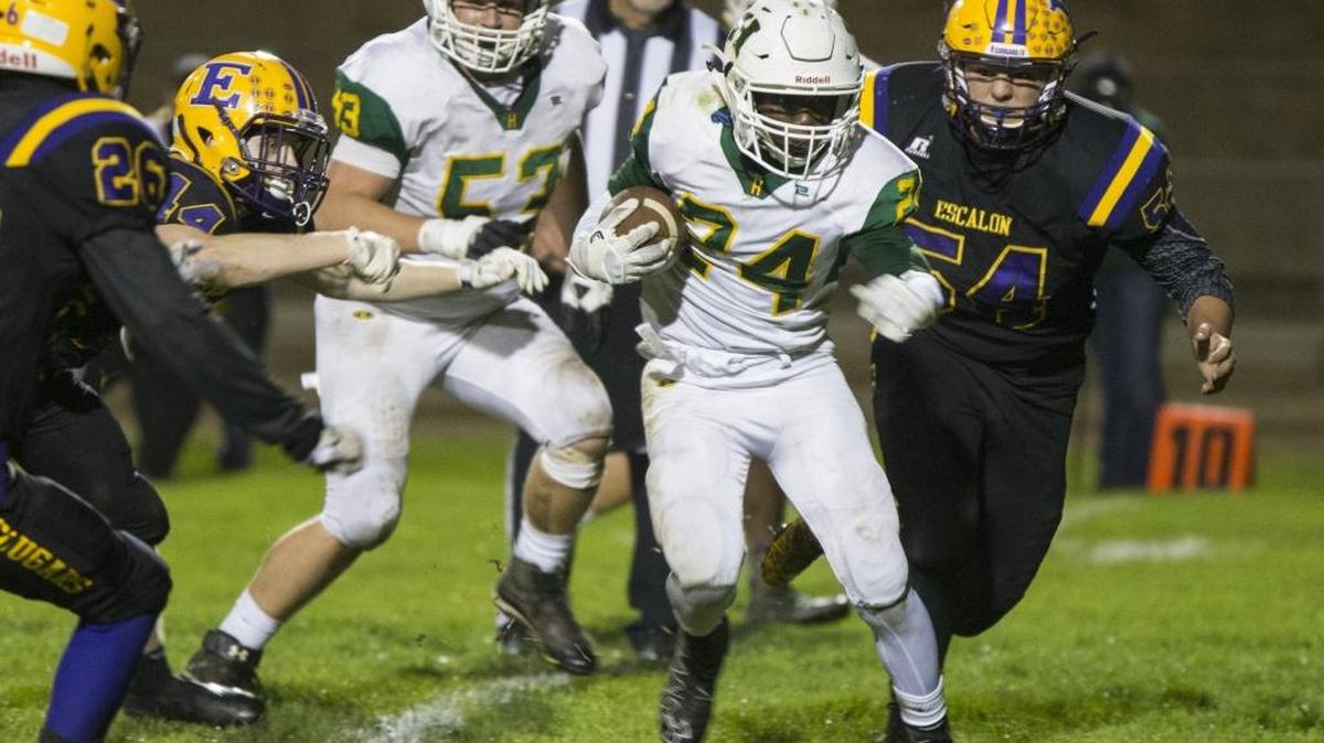 Hilmar High’s Isaac Sharp (24) gets chased down by the Escalon High defense during the first half. Hilmar High traveled to Escalon High for the second round of Sac-Joaquin Section Division VI playoffs Friday Nov. 17th 2017.