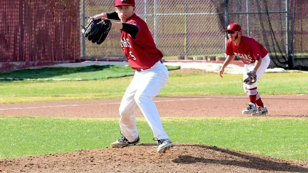 Golden Valley pitcher Brady Mello fires to first on a pick-off attempt. Monday, April 10, 2017 in Merced.